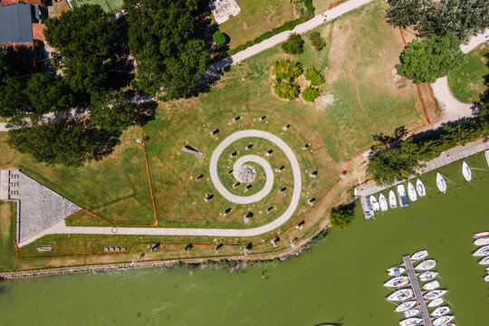 Aerial view of a twirling walking path along Trasimeno Lake coastline, Perugia, Umbria, Italy.