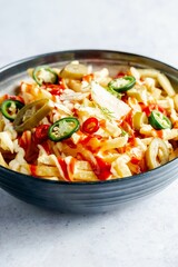 Bowl of french fries topped with sauce