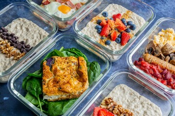 Closeup of  vibrant and transparent bowls of oatmeal topped with different ingredients on the table