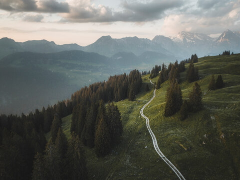 Aerial drone view a road through the woods of Wildhaus in St. Gallen, Switzerland.