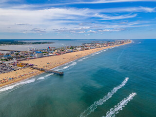 Aerial view of people on the beach and pier in Ocean City, Maryland, United States.