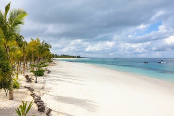 Fototapeta na wymiar Beautiful tropical beach with white sand and clear blue water on the island of Zanzibar