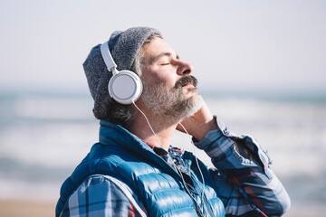Close-up of a man listening to music on headphones, a look of concentration and joy on his face