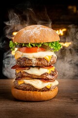Closeup shot of a delicious hamburger with bacon, lettuce, tomato, and cheese.