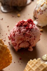 Closeup of pink and delicious ice cream near cone breads on a table