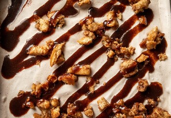 delicious ice cream cake topped with a generous drizzle of chocolate syrup and crunchy nuts