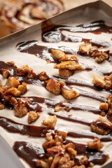 delicious ice cream cake topped with a generous drizzle of chocolate syrup and crunchy nuts