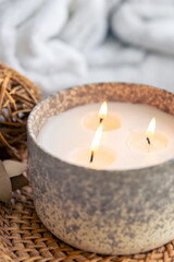 A large burning candle on a blurred background.