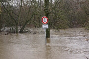 A warning sign warns against the floods of the river Lahn in Marburg - obrazy, fototapety, plakaty
