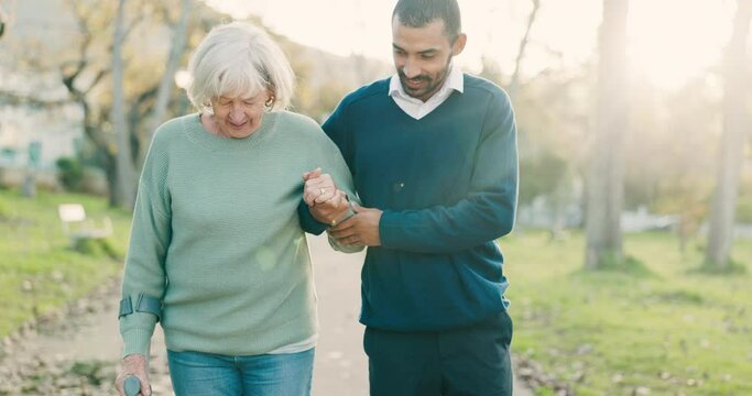 Walk, crutch and man with his senior mother in a park for support, help or balance in nature. Medical, wellness and young male person doing a cardio exercise with his elderly mom in an outdoor garden