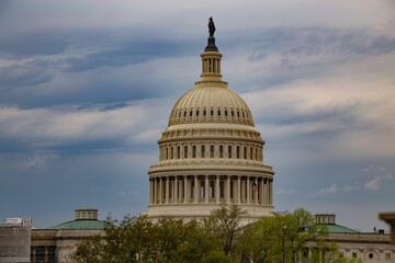 Dome of the United States Capitol against the backdrop of a cloudy sky. Washington, United States.