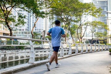 An unidentified man jogging in a urban scenery.