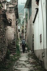 Elderly man walking on a deserted, rural road in Southern China