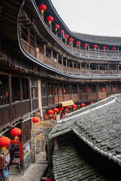 Red lanterns suspended from the walls of Fujian tulou. Longyan City, China.