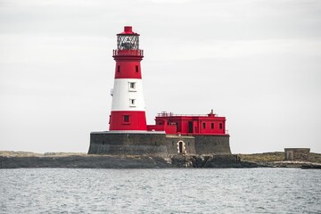 a large white and red lighthouse with a tower on top of it