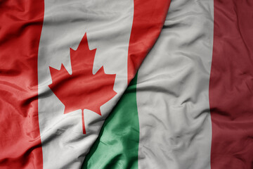 big waving realistic national colorful flag of canada and national flag of italy .