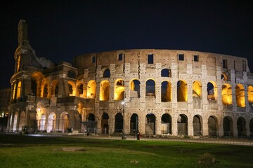 Fototapeta na wymiar Iconic Coliseum of Rome, Italy illuminated by the lights at night