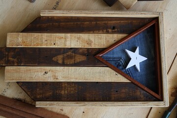 Wooden frame featuring the United States flag, set against a wooden background
