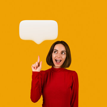Happy millennial woman pointing upwards at blank comminication bubble