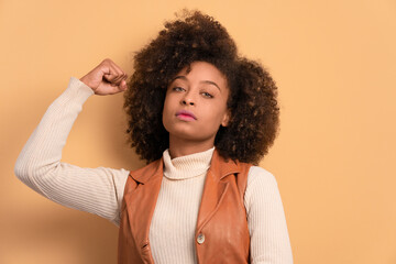 confident brazilian woman flexing arms in all beige colors. strong, power, proud concept.