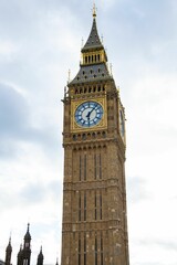Fototapeta na wymiar Iconic clock tower stands majestic in the foreground of a picturesque landscape in London, England