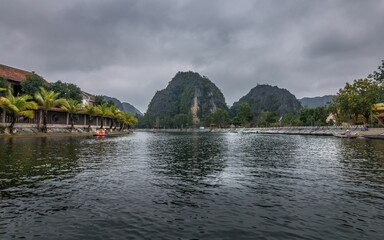 Tranquil lake in Vietnam surrounded by lush green mountains