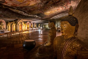 Interior view of the Dambulla Cave Temple in Sri Lanka, featuring statues of the Buddha