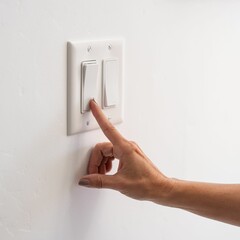 Closeup of a person turning the light switch off indoors