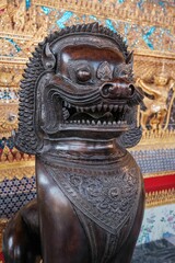 closeup of a bronze statue of a mythical creature in The Temple of the Emerald Buddha in Bangkok
