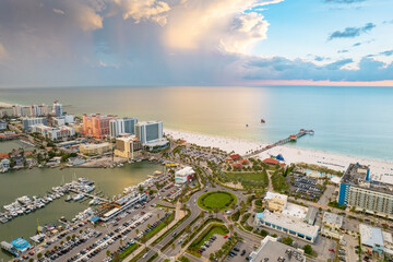 Fototapeta na wymiar Florida. Panorama of Clearwater Beach FL. Summer vacations in Florida. Beautiful View on Hotels and Resorts on Island. Sunset time. Ocean water. American Coast. Shore Gulf of Mexico. Aerial view
