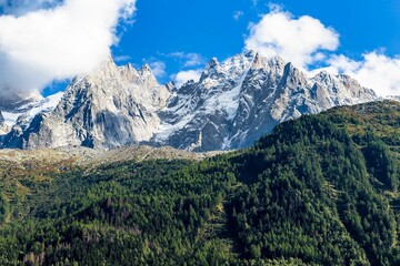 Fototapeta na wymiar Landscape of a beautiful alpine mountain range covered in greenery on a sunny day