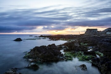 Stock photo depicts a tranquil seascape at sunrise in Tunisia