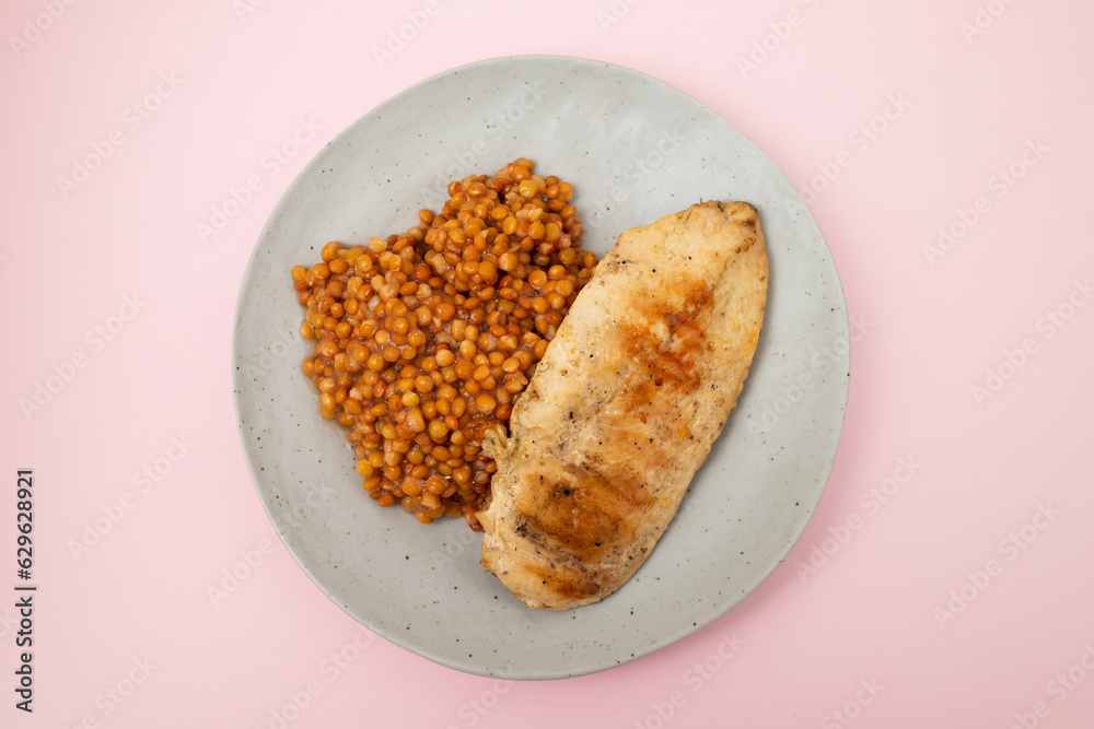 Wall mural Bowl of boiled red lentils and chicken breast in a ceramic bowl