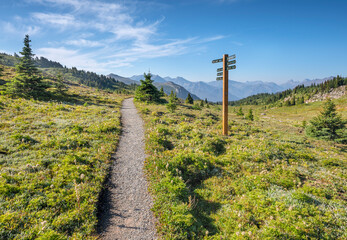 Hiking trail with directional sign post at Sunshine Meadows on the Continental Divide between...