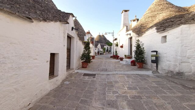 Alberobello Italy - traditional trulli houses with conical stone roofs. Famous landmark, travel destination and tourist attraction near Bari in Puglia, Europe. Street with ancient architecture.