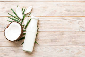 coconut products on white wooden table background. Dairy free milk substitute drink, Flat lay healthy eating