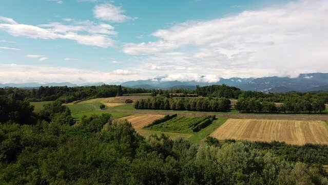 Drone elevation on a panoramic view of prealps and farmlands in Lombardy Northern Italy