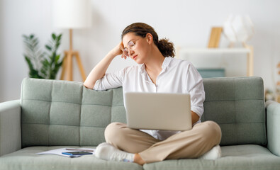 Tired woman working on laptop