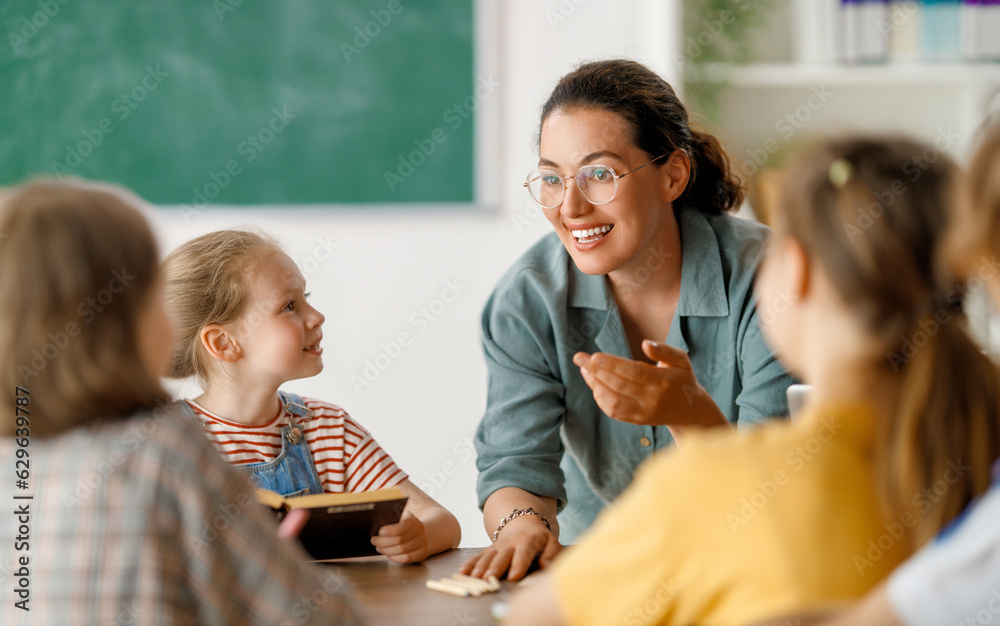 Wall mural Happy kids and teacher at school