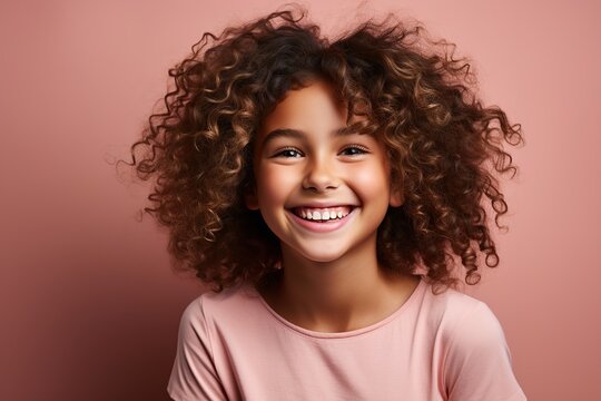 portrait of a laughing girl on a pink background