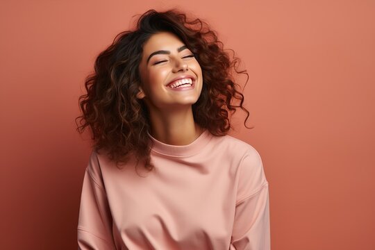 portrait of a laughing girl on a pink background