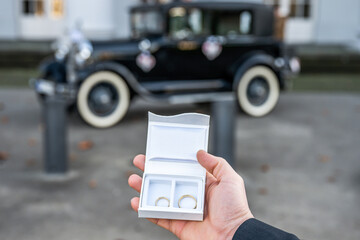 Groom hold in hand Romantic marriage couple wedding Symbols rings in a white box