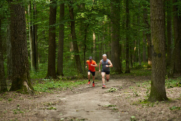 Two men running in the forest