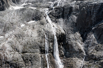 Fototapeta na wymiar close-up aerial view of the waterfalls produced by the left section of the Adamello glacier in Trentino