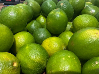 Bunch of limes for sale at a grocery store, fresh fruit