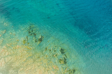 Fototapeta na wymiar vertical aerial view of the rocky coast of garda lake near sirmione