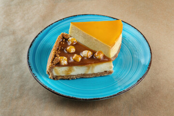 Nut vanilla cheesecake with salty homemade caramel on a blue plate.