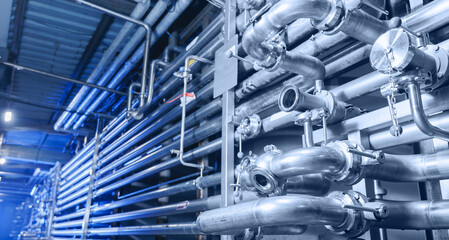 Pipes stainless steel brewing equipment, large reservoirs or tanks in modern beer factory. Brewery...