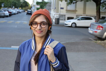 Ethnic female hipster listening to music outdoors 