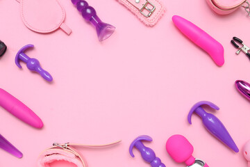 Frame made of sex toys on pink background